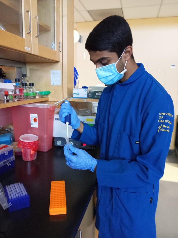 Neeraj Senthil pipetting a solution