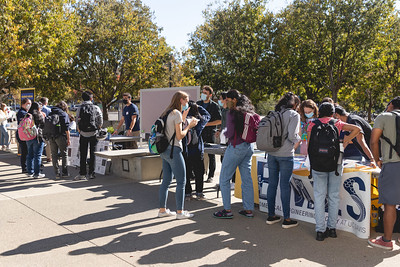 Crowds of students gather at the BME open house and look at information presented by faculty at tables