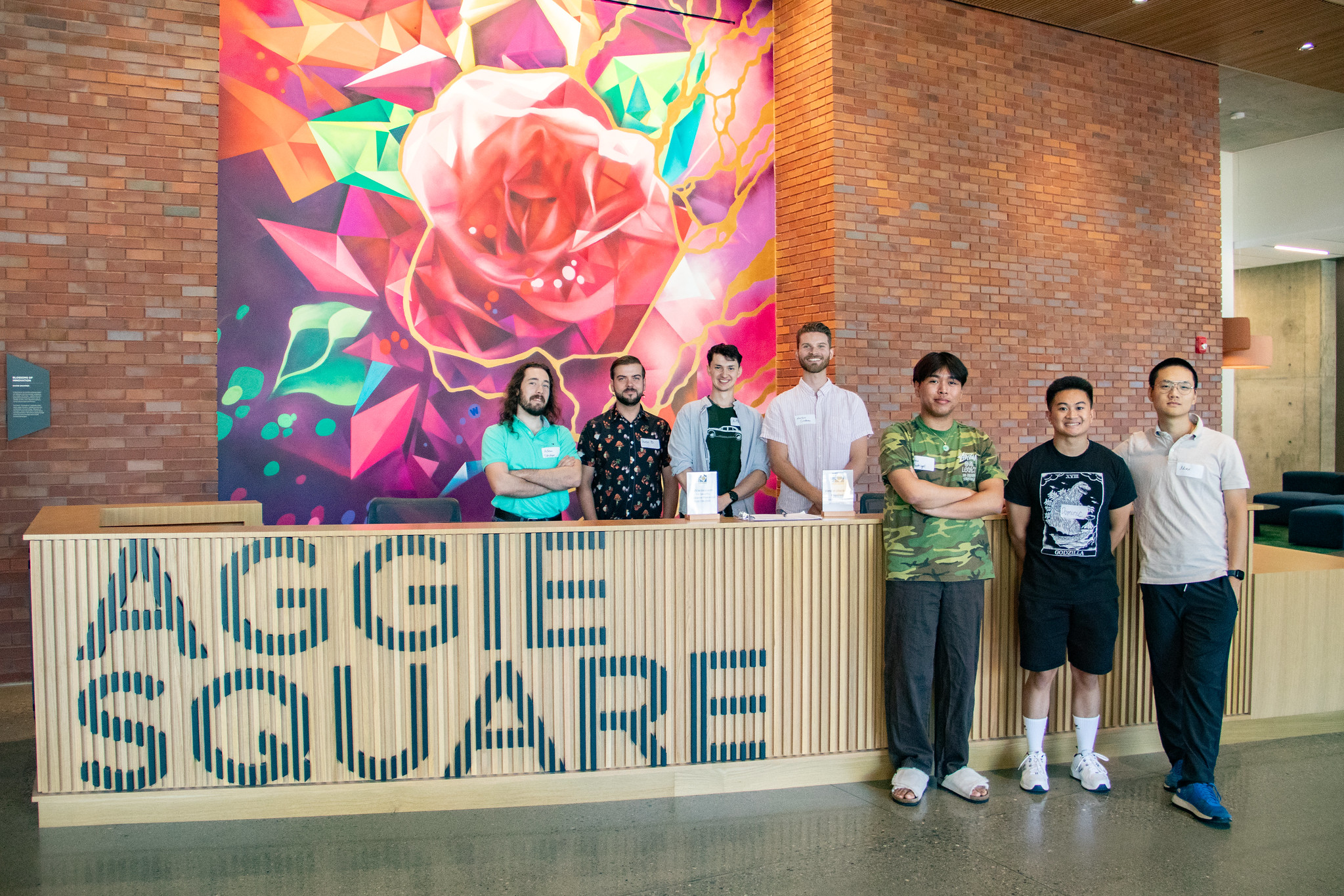 The first student cohort poses in the lobby of Aggie Square