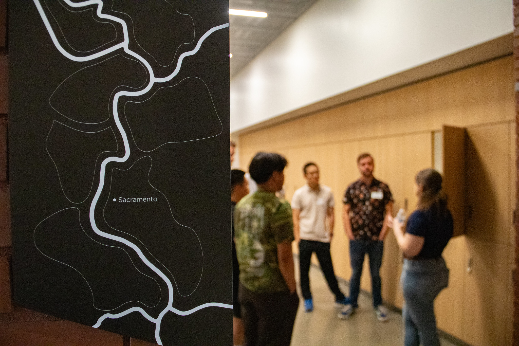 Students tour Aggie Square and a map with Sacramento pinpointed is in the foreground