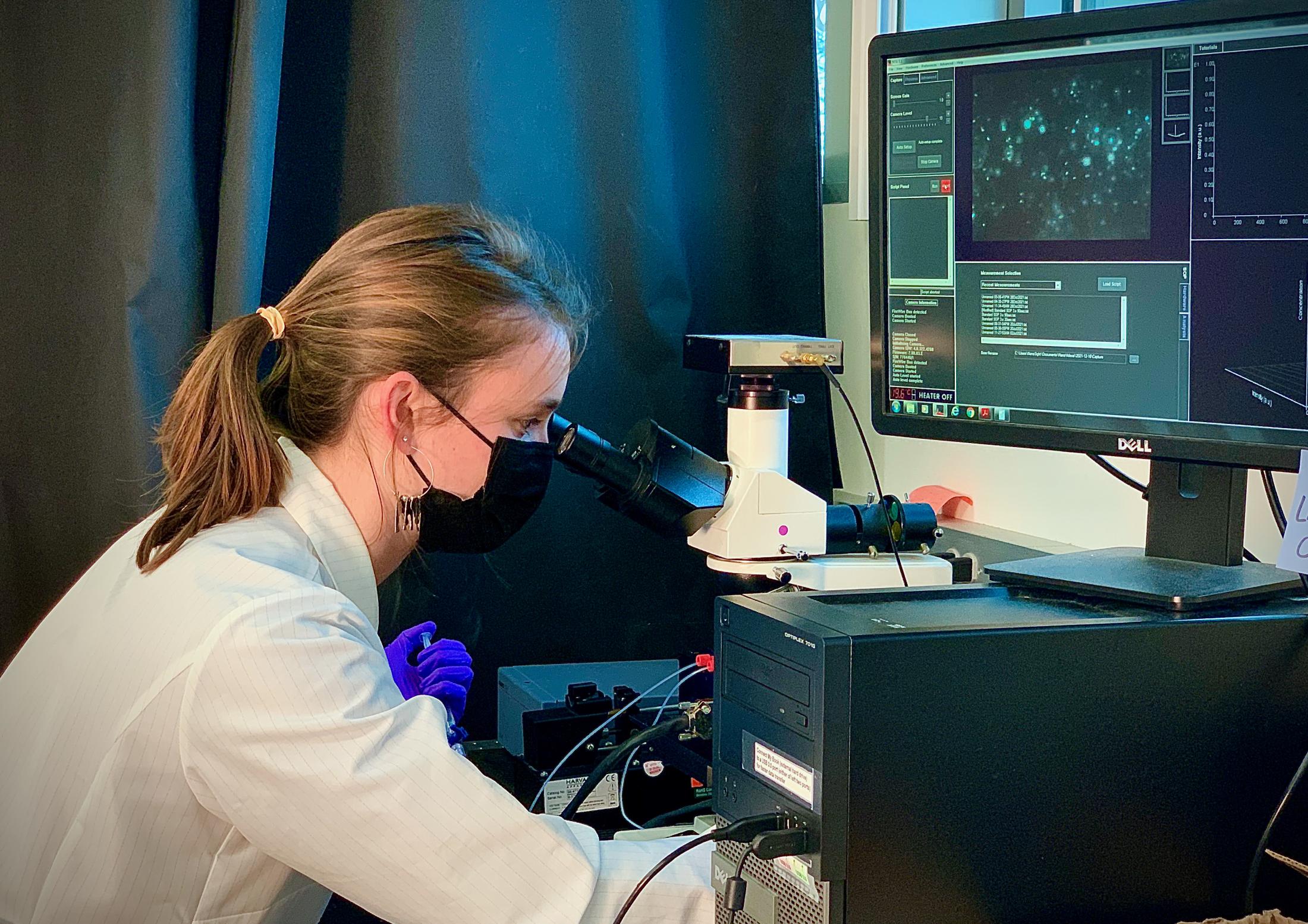 Young blonde woman working in a science lab