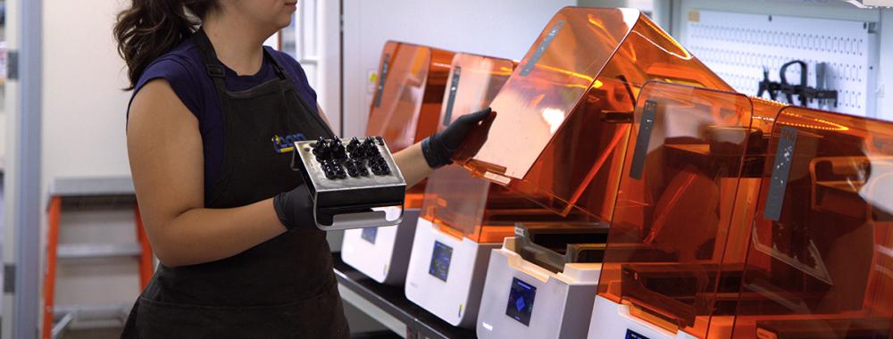 Person loads 3D printers in the TEAM Lab