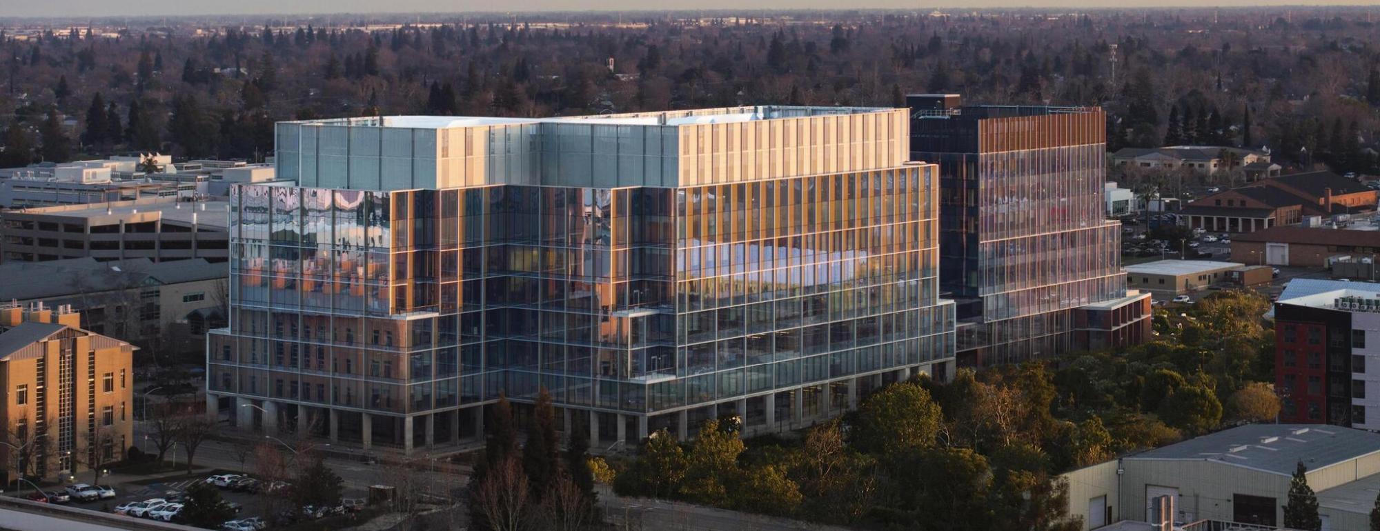 A large building in Sacramento on the UC Davis campus with many glass windows called Aggie Square
