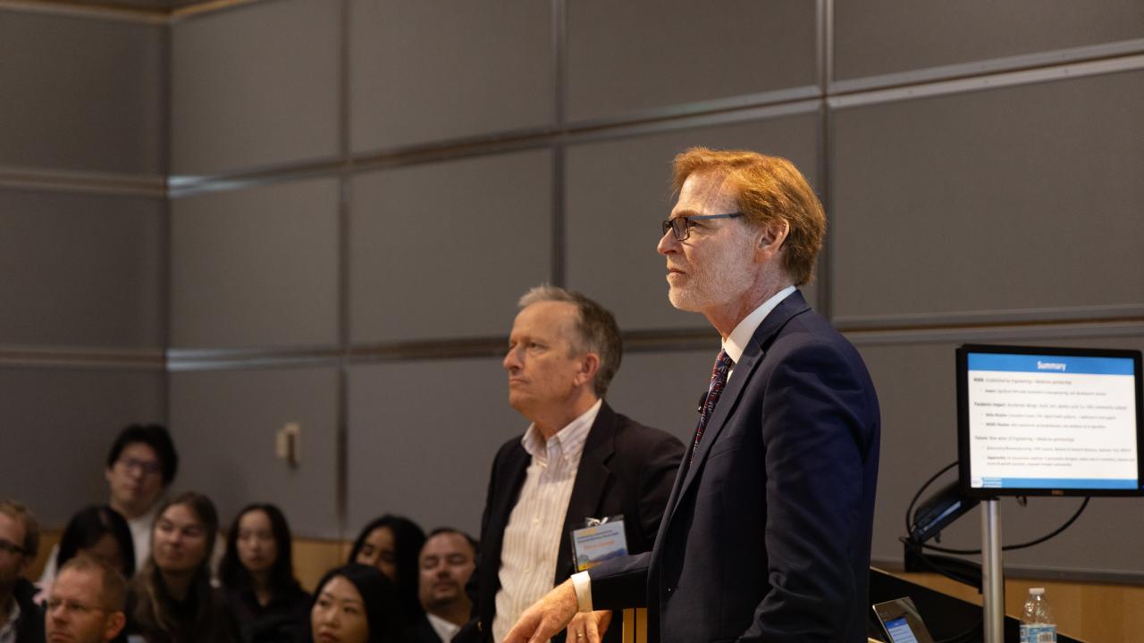 Two people in front of an audience