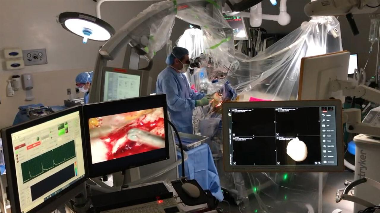 surgeon in operating room performing flim system surgery