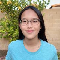 East Asian woman with glasses, dark hair, and a blue top