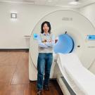 Xiaoyu Duan stands before a uEXPLORER total-body PET scanner