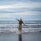 Humphries standing in shallow beach waves